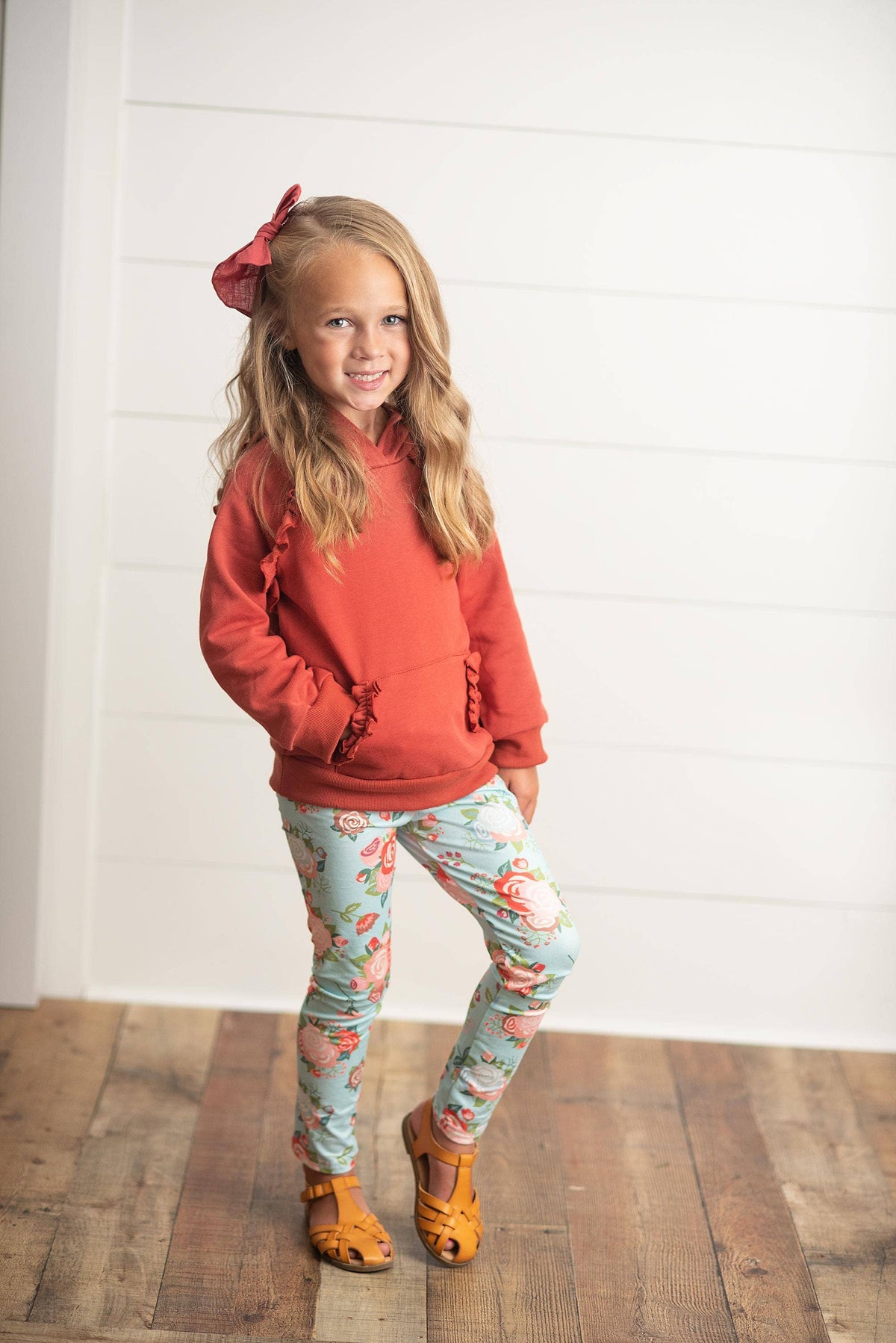 Girl wearing a boutique floral dress from Wild Lapin Children's Boutique's Girls Collection