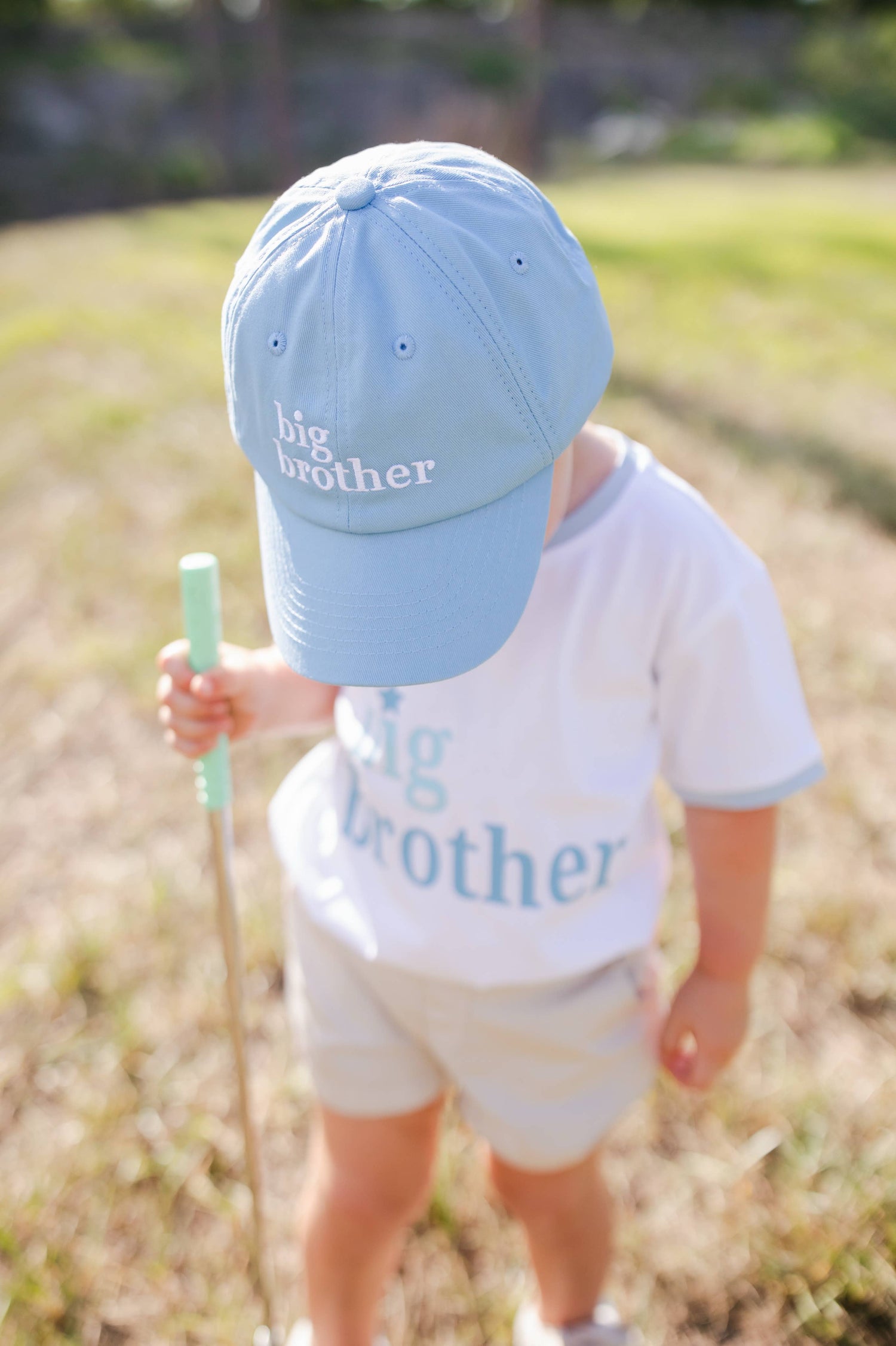 Child wearing big brother hat and big brother t-shirt from Wild Lapin Children's Boutique